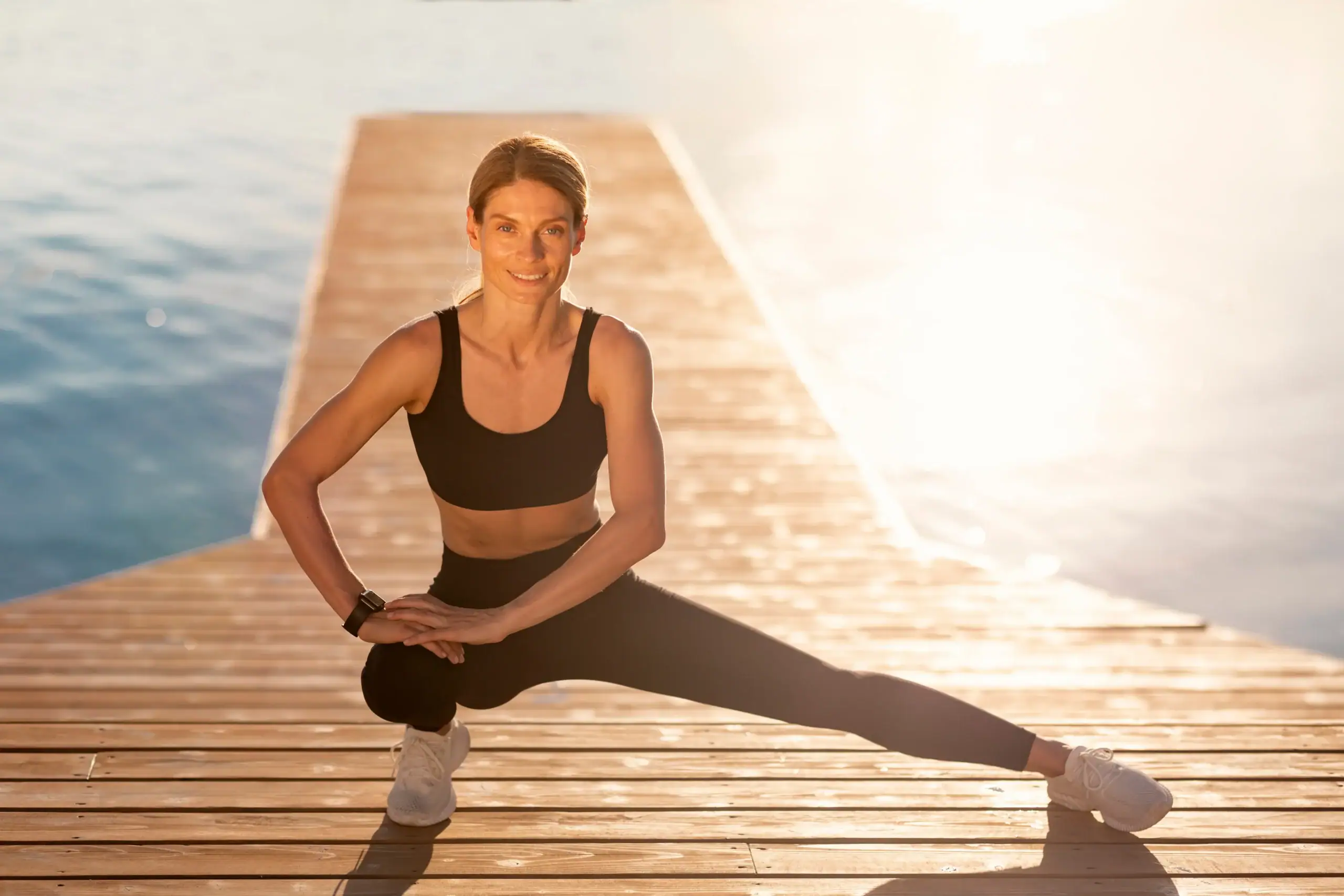 Healthy middle-aged woman getting exercise outdoors by the water