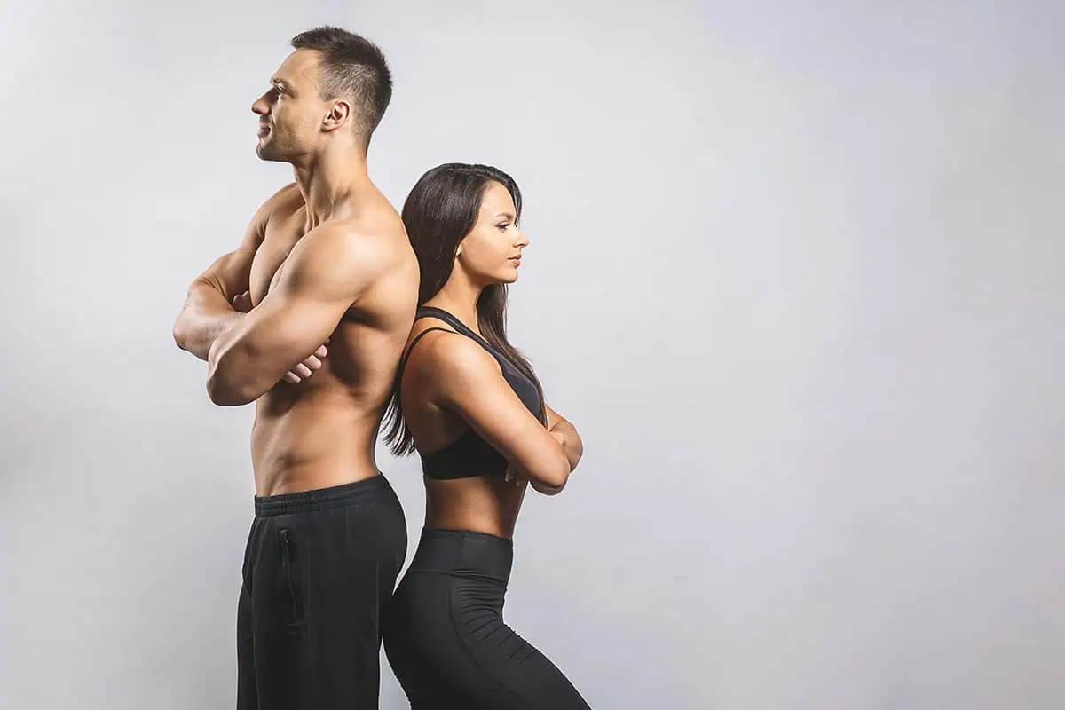 A man and woman standing back to back