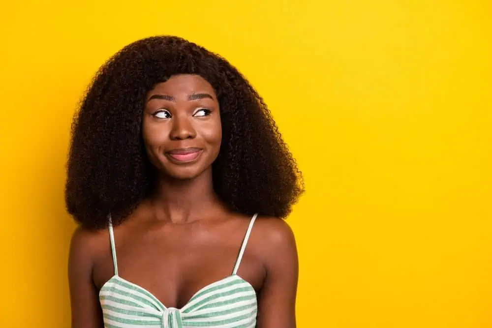 Pretty young woman wearing a striped top with spaghetti straps
