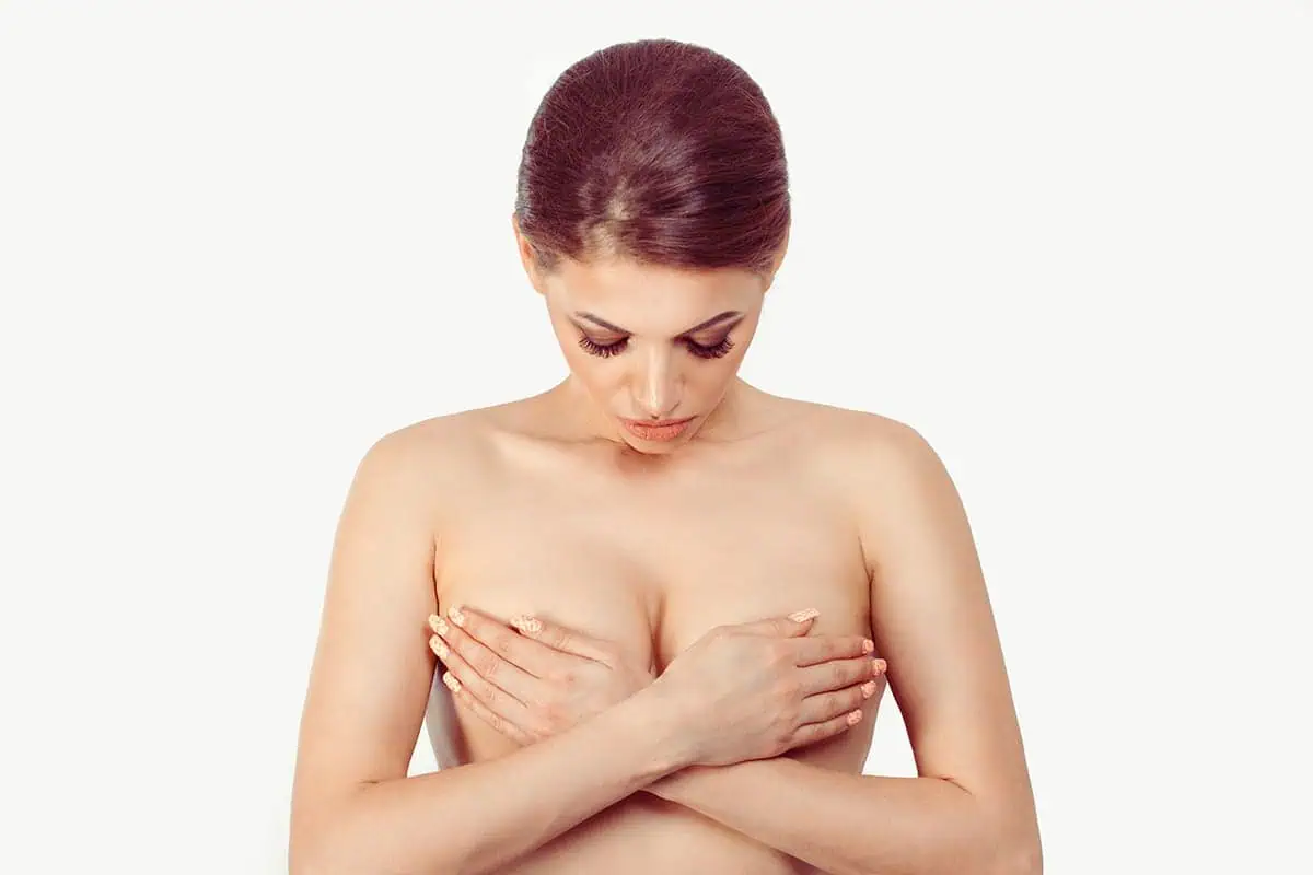 Photo of woman holding her breasts in her hands