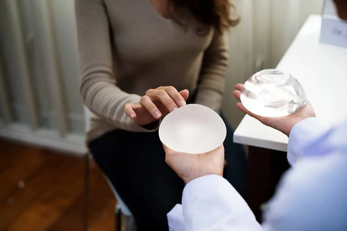 Woman examining breast implants